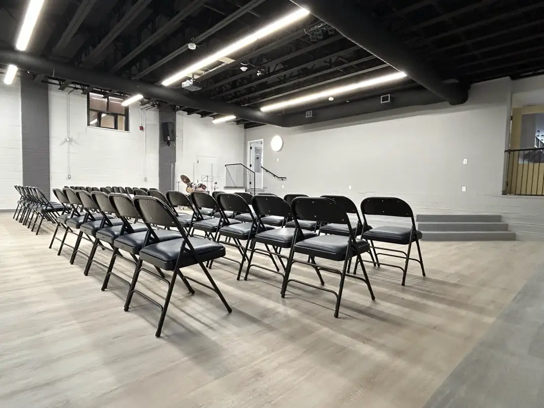 Large hall with stage and chair rows at the Long Branch facility