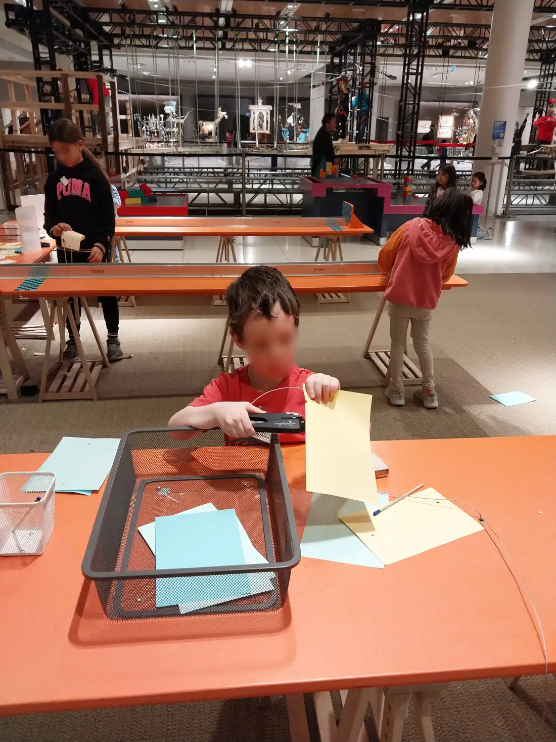 Child with a paper airplane at the science museum