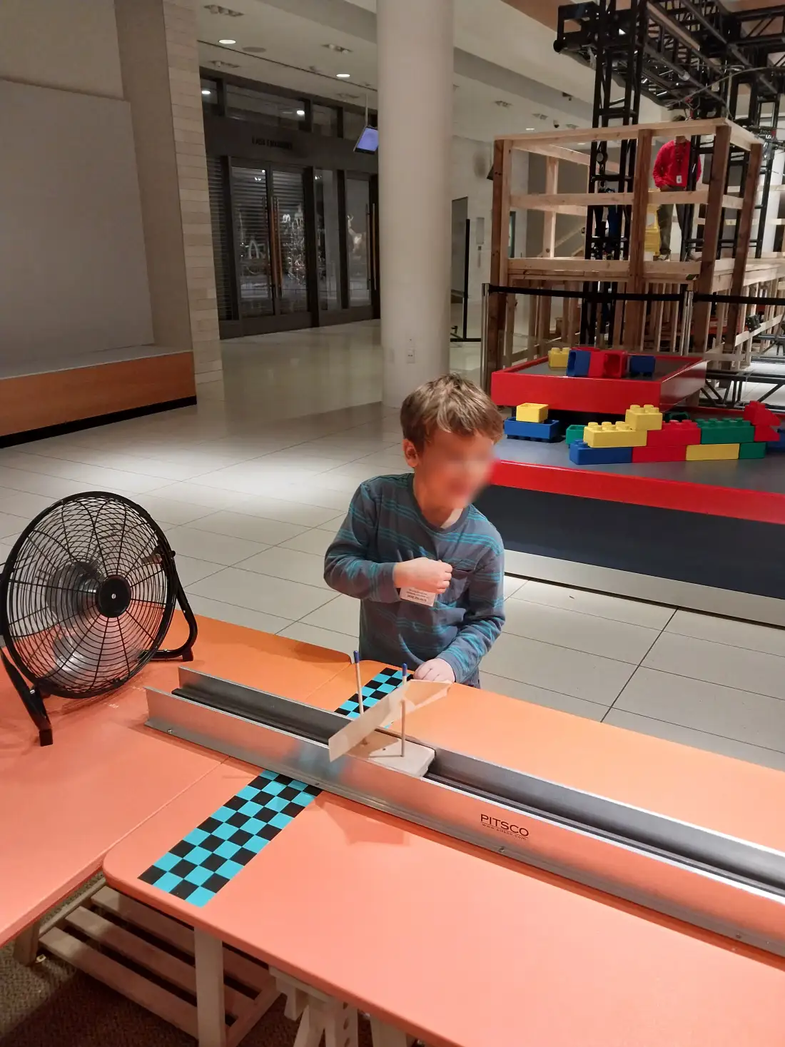 Child with a wind-powered sail car at the science museum