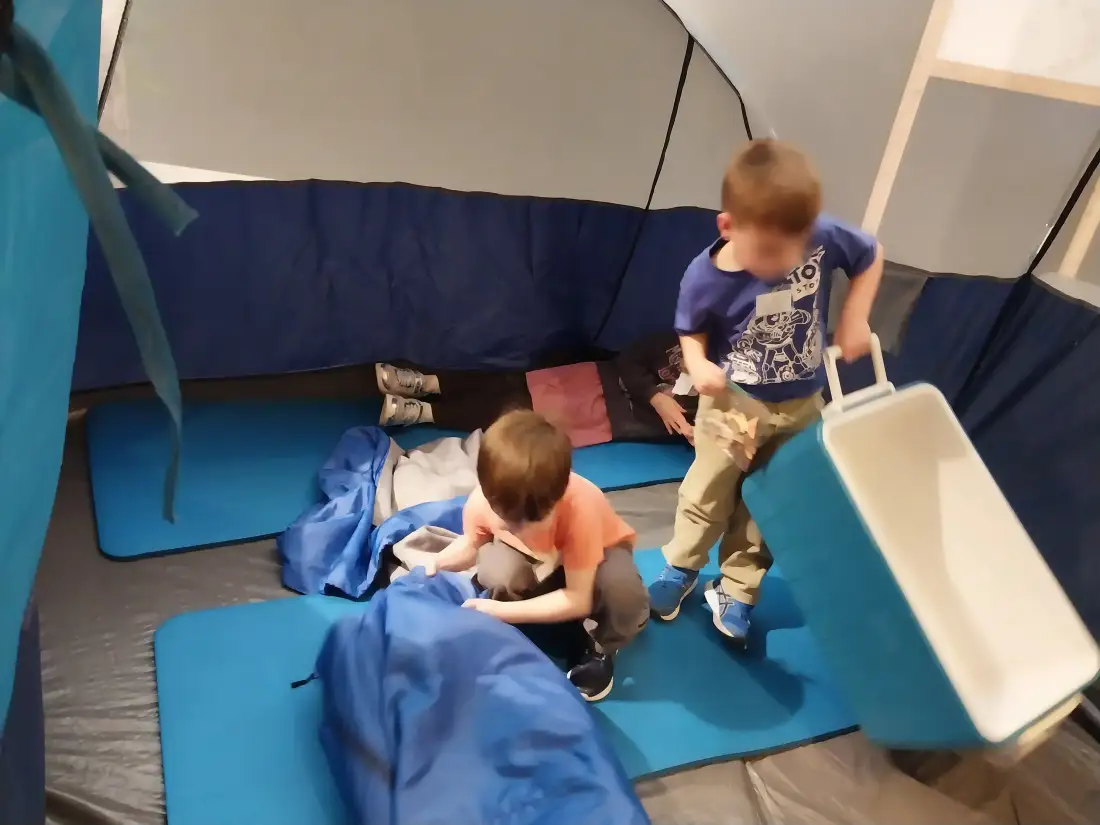 Children playing inside a camping tent