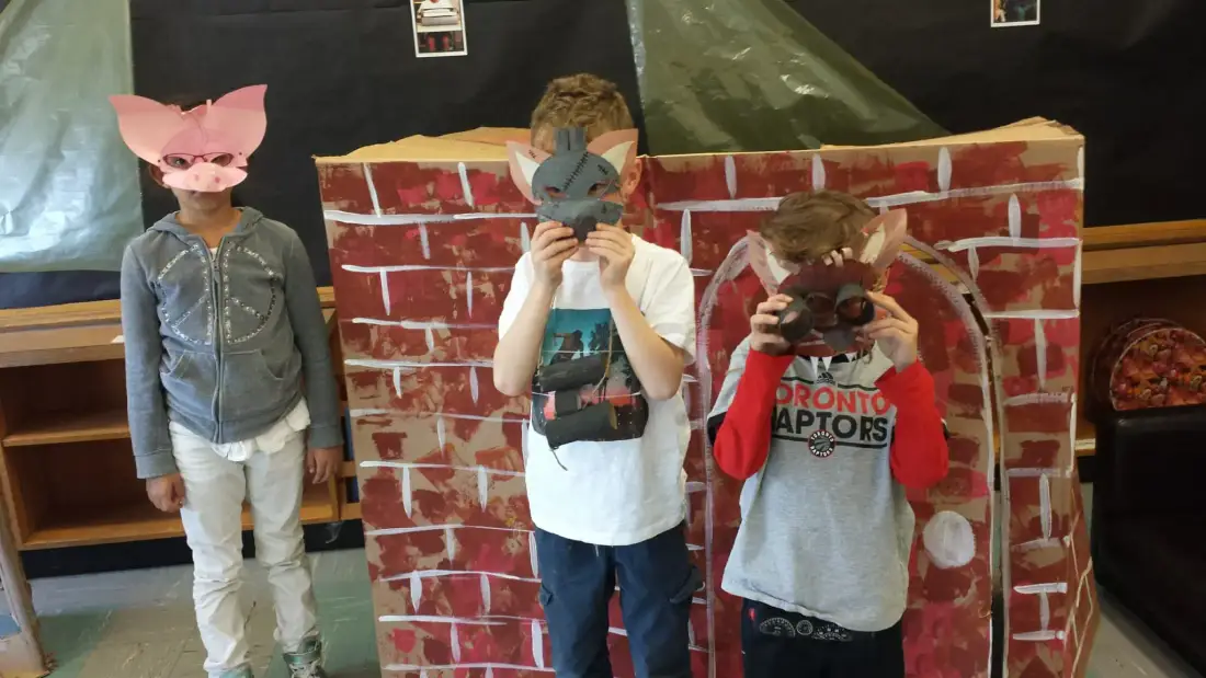 Children performing Three Little Pigs with handmade masks